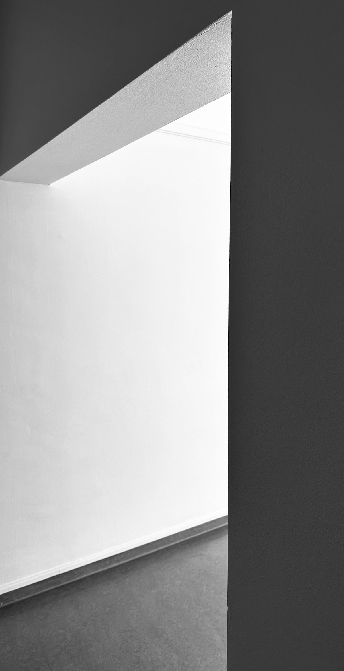 a black and white photo of a person sitting on a bench